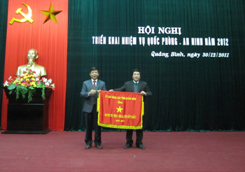 Đồng chí Chủ tịch UBND tỉnh tặng cờ thi đua xuất sắc cho huyện Tuyên Hóa. Ảnh: P.V