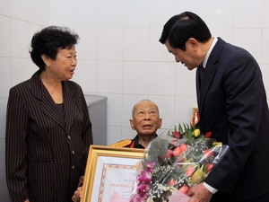 Chủ tịch nước Trương Tấn Sang trao tặng danh hiệu Anh hùng Lực lượng vũ trang nhân dân cho ông Nguyễn Đức Hùng. (Ảnh: TTXVN)