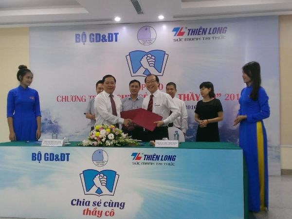 Ông Nguyễn Phi Long và Giám đốc Tập đoàn Thiên Long Võ Văn Thành Nghĩa ký kết thỏa thuận hợp tác tổ chức chương trình Chia sẻ cùng thầy cô năm 2016. (Ảnh: PM/Vietnam+)