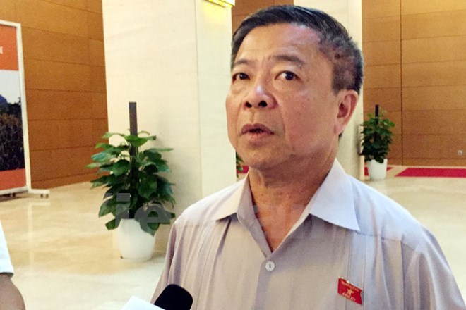 Ông Võ Kim Cự trong lần trả lời báo chí tại hành lang kỳ họp thứ 1, Quốc hội khóa XIV. (Ảnh: P.T/Vietnam+)