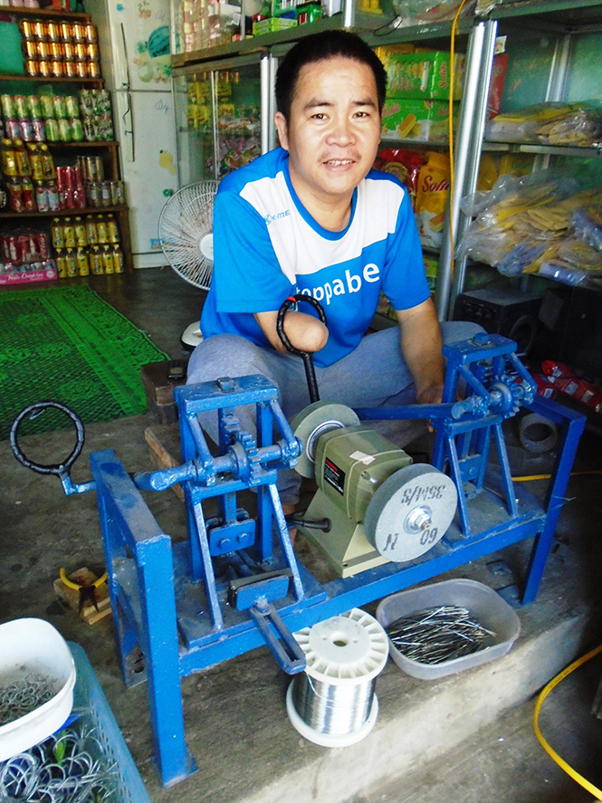 Anh Phạm Thanh Nam đang làm việc cùng chiếc máy chế tạo lưỡi câu.