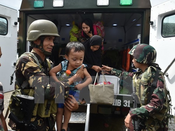 Binh sỹ Philippines giúp sơ tán người dân khỏi các khu vực xung đột tại Marawi. (Nguồn: AFP/TTXVN)