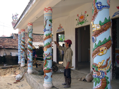 Thợ nề Diêm Điền đắp nổi hình rồng bằng xi măng  và khảm đá men trên trụ.