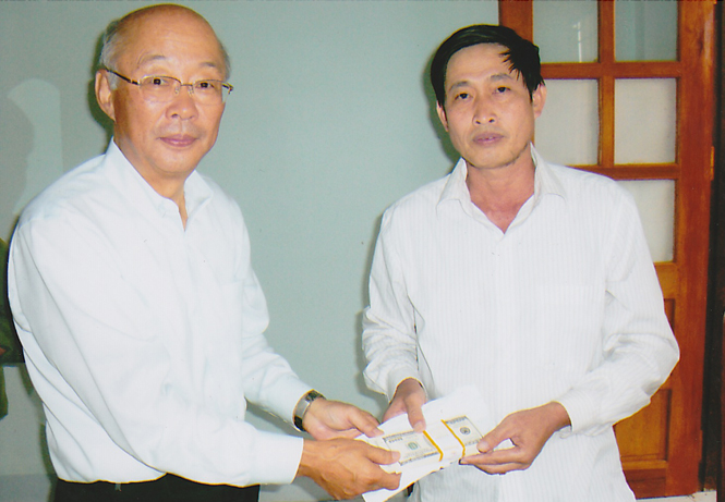Ông Sato trao tiền cho lãnh đạo xã Châu Hóa  để xây dựng trường mầm non.