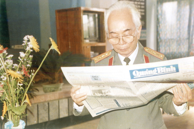 Đại tướng Võ Nguyên Giáp đọc Báo Quảng Bình nhân chuyến về thăm quê tháng 11-2004. Ảnh: Tư liệu