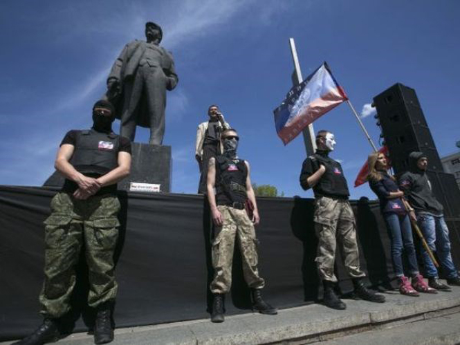 Các nhà hoạt động ủng hộ Nga đứng trước tượng đài Lenin trong một cuộc biểu tình ở Donetsk, Đông Ukraine hôm 27-4. (Ảnh: Reuters)