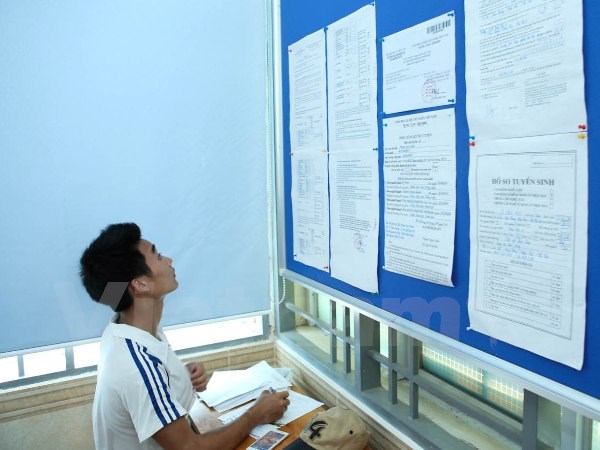  Thí sinh xem thông tin xét tuyển tại Đại học Công nghiệp Hà Nội. (Ảnh: Lê Minh Sơn/Vietnam+)